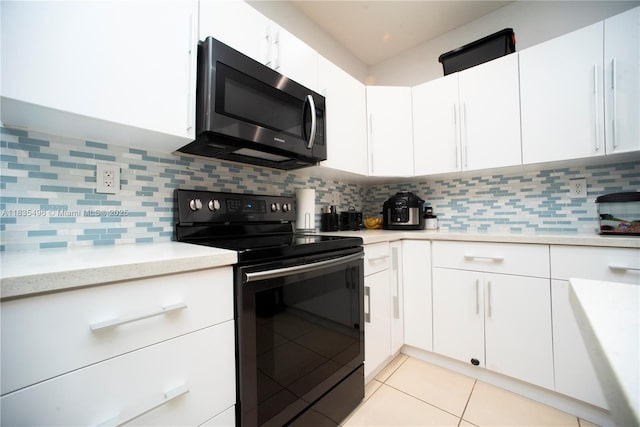 9323 SW 227th St Unit 2-5, Cutler Bay, FL 33190 - kitchen featuring stainless steel microwave, black / electric stove, white cabinets, and light tile patterned flooring