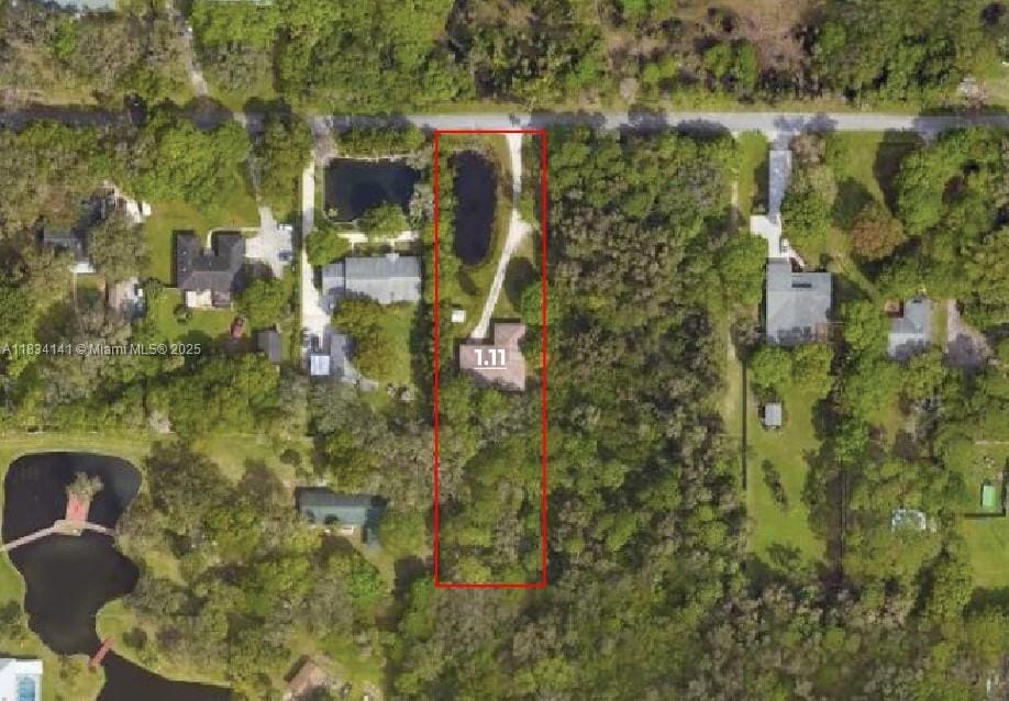 aerial view of property and surrounding area featuring property parcel outlined