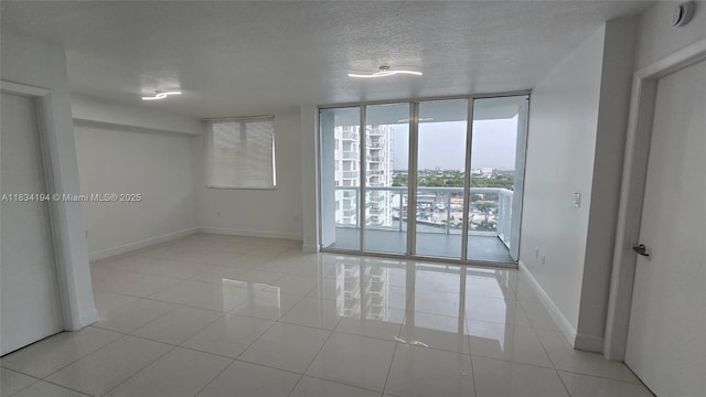 1871 NW S River Dr Unit 1506, Miami, FL 33125 - unfurnished room featuring expansive windows, light tile patterned floors, and a textured ceiling