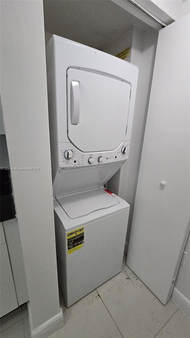 1871 NW S River Dr Unit 1506, Miami, FL 33125 - laundry room with estacked washer and dryer and baseboards