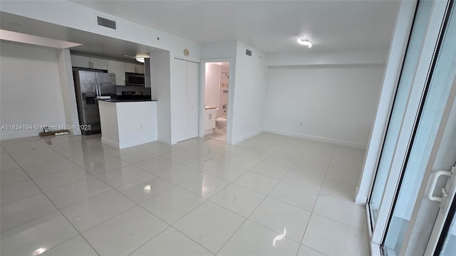 1871 NW S River Dr Unit 1506, Miami, FL 33125 - unfurnished living room featuring light tile patterned floors and baseboards
