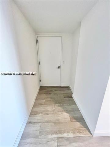 45 SW 9th St Unit 3009, Miami, FL 33130 - corridor with baseboards and light wood-type flooring