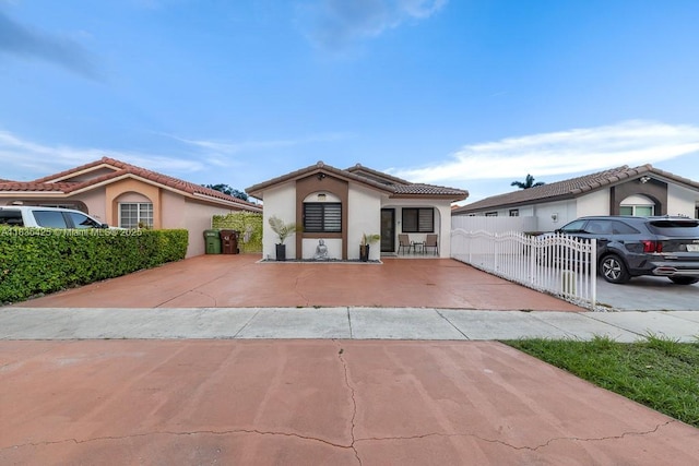 7029 W 29th Way, Hialeah, FL 33018 - mediterranean / spanish-style home featuring stucco siding, a gate, and a tile roof
