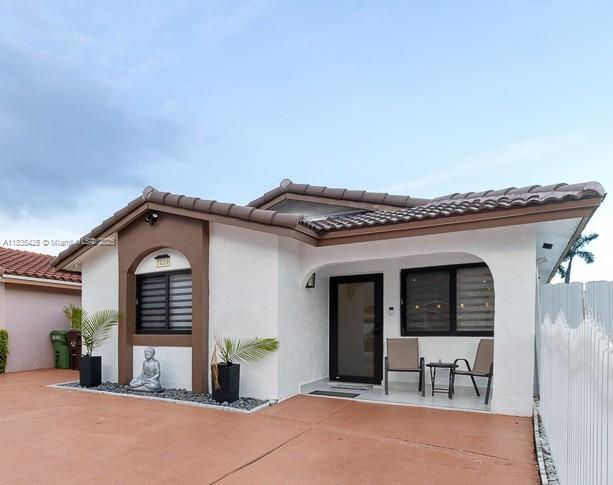 7029 W 29th Way, Hialeah, FL 33018 - view of front of home with stucco siding and a tiled roof