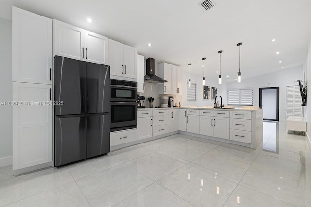 7029 W 29th Way, Hialeah, FL 33018 - kitchen with freestanding refrigerator, wall chimney exhaust hood, double oven, a peninsula, and white cabinets