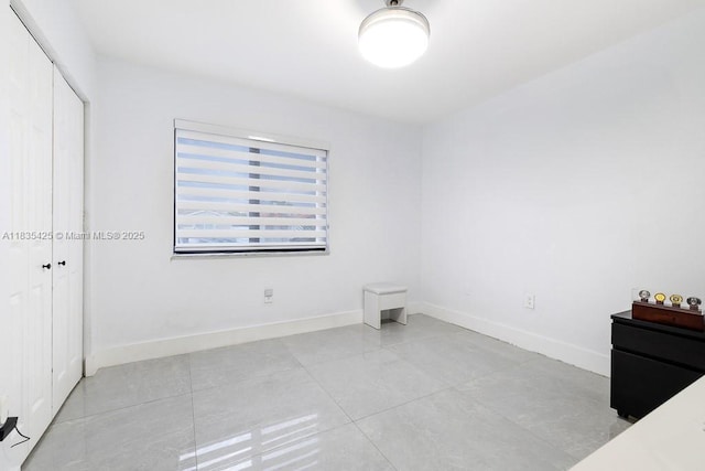 7029 W 29th Way, Hialeah, FL 33018 - unfurnished bedroom with a closet and light tile patterned flooring