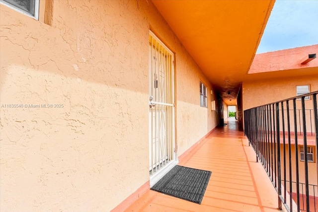 1890 W 56th St Unit 1411, Hialeah, FL 33012 - view of exterior entry with stucco siding and a balcony