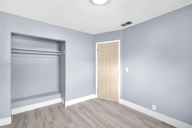 1408 9th St, West Palm Beach, FL 33401 - unfurnished bedroom with wood finished floors and a closet