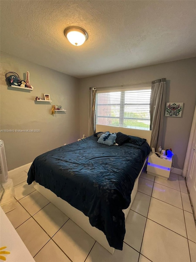13715 Kendale Lakes Cir Unit A-116, Miami, FL 33183 - bedroom featuring a textured ceiling and light tile patterned floors