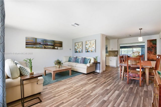 7051 SW 29th St, Miramar, FL 33023 - living room featuring light wood finished floors and baseboards