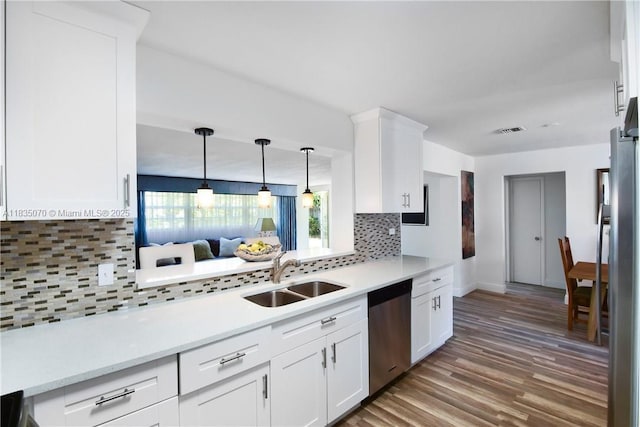 7051 SW 29th St, Miramar, FL 33023 - kitchen with stainless steel appliances, light countertops, light wood-style flooring, and decorative backsplash