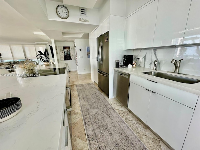 16400 Collins Ave Unit 841, Sunny Isles Beach, FL 33160 - kitchen with appliances with stainless steel finishes, white cabinetry, modern cabinets, and light stone countertops
