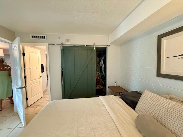 280 SW 20th Rd Unit 404, Miami, FL 33129 - bedroom with light tile patterned floors and a barn door
