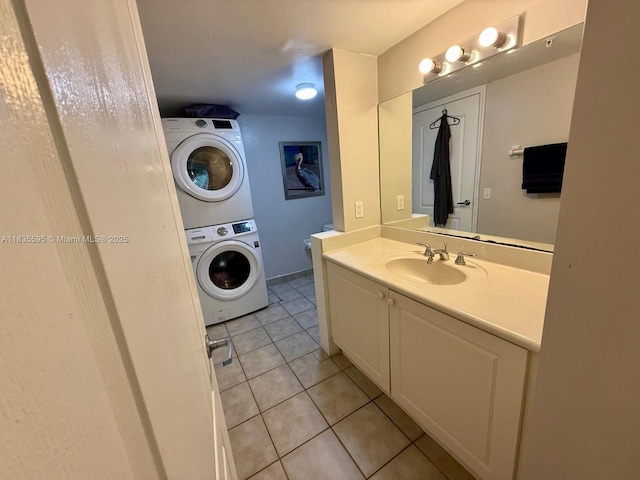 280 SW 20th Rd Unit 404, Miami, FL 33129 - bathroom featuring stacked washer and clothes dryer, tile patterned floors, and vanity