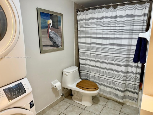 280 SW 20th Rd Unit 404, Miami, FL 33129 - bathroom featuring stacked washer / dryer, tile patterned floors, and curtained shower