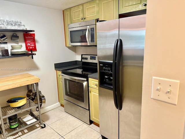 280 SW 20th Rd Unit 404, Miami, FL 33129 - kitchen with appliances with stainless steel finishes, dark countertops, and light tile patterned flooring