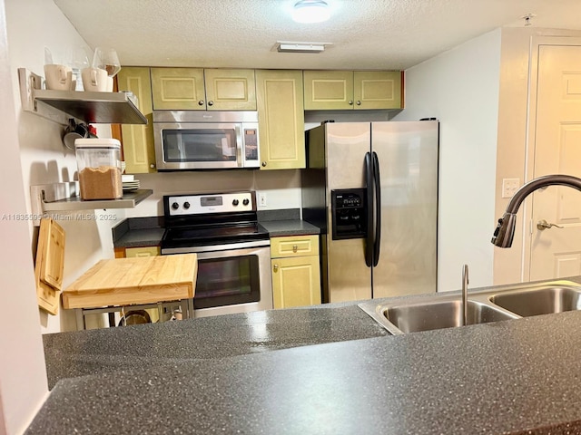 280 SW 20th Rd Unit 404, Miami, FL 33129 - kitchen with stainless steel appliances, dark countertops, and a textured ceiling