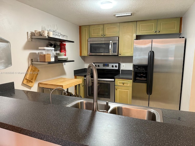 280 SW 20th Rd Unit 404, Miami, FL 33129 - kitchen with stainless steel appliances, a textured ceiling, and dark countertops