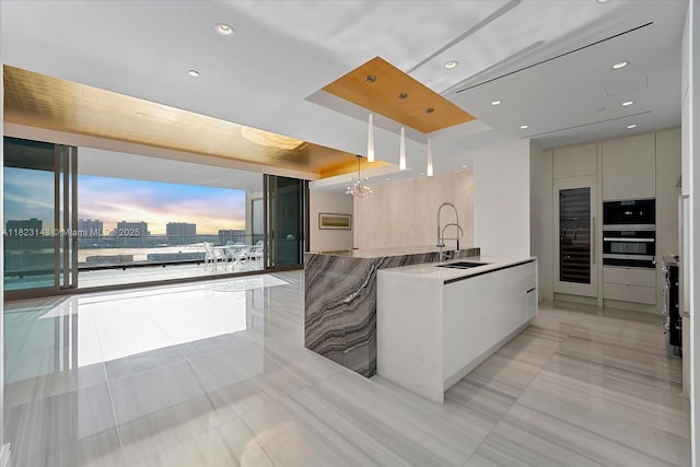17901 S Collins Ave Unit 1506, Sunny Isles Beach, FL 33160 - kitchen with modern cabinets, light tile patterned floors, stainless steel oven, decorative light fixtures, and recessed lighting