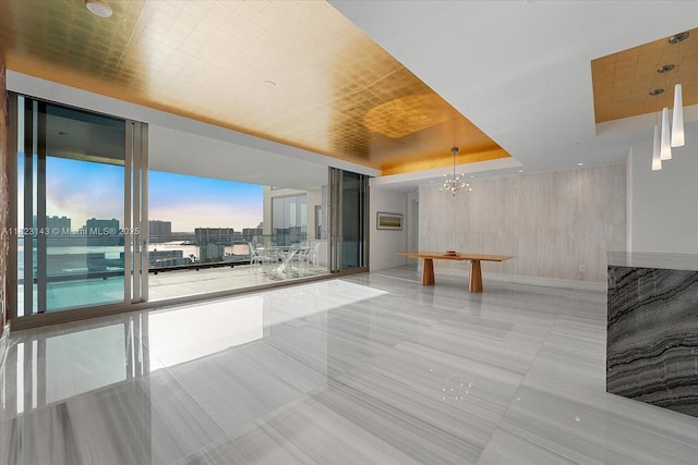 17901 S Collins Ave Unit 1506, Sunny Isles Beach, FL 33160 - tiled spare room with a chandelier, a raised ceiling, a city view, and expansive windows