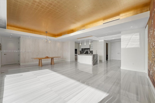 17901 S Collins Ave Unit 1506, Sunny Isles Beach, FL 33160 - unfurnished living room with a chandelier, a fireplace, and a tray ceiling