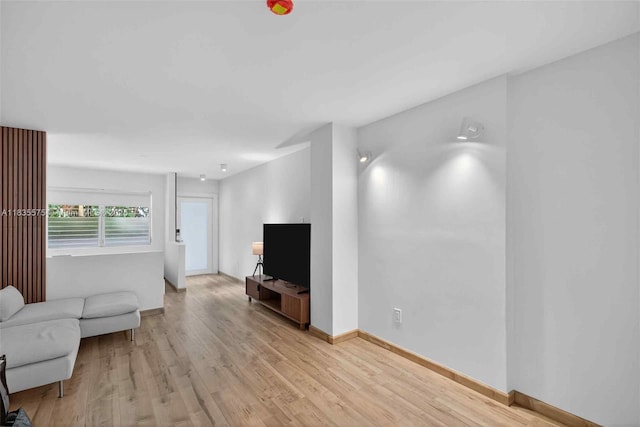 1334 Euclid Ave Unit 4, Miami Beach, FL 33139 - unfurnished living room featuring light wood-style floors and baseboards