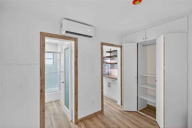1334 Euclid Ave Unit 4, Miami Beach, FL 33139 - corridor with an AC wall unit and light wood-style floors