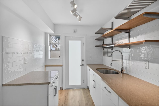 1334 Euclid Ave Unit 4, Miami Beach, FL 33139 - kitchen with open shelves, tasteful backsplash, light wood finished floors, and white cabinetry