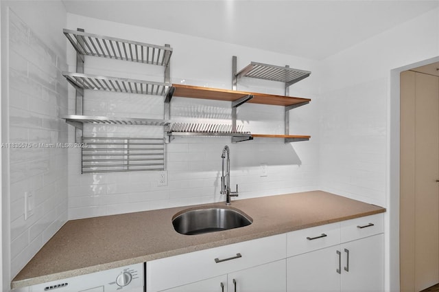 1334 Euclid Ave Unit 4, Miami Beach, FL 33139 - kitchen with decorative backsplash, open shelves, washer / clothes dryer, and white cabinets