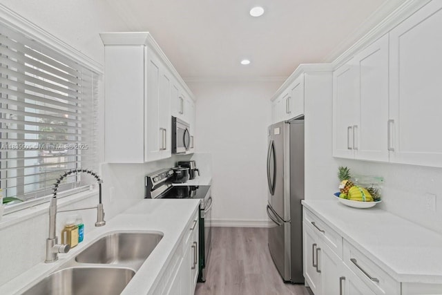 1941 NW 151st St, Miami Gardens, FL 33054 - kitchen featuring appliances with stainless steel finishes, white cabinetry, wood finished floors, light countertops, and recessed lighting