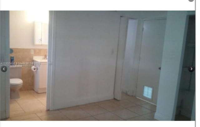 3901 SW 112th Ave Unit 25, Miami, FL 33165 - bathroom with tile patterned flooring, vanity, and tile walls