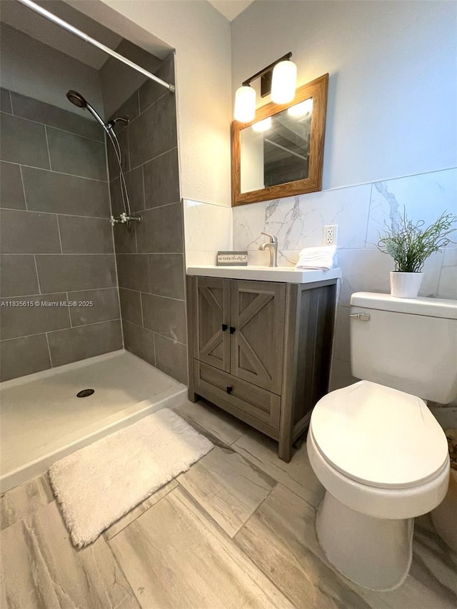 1148 N Singleton Ave, Titusville, FL 32796 - full bath with tile walls, a tile shower, vanity, and wainscoting
