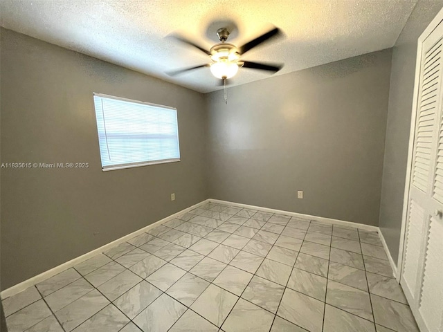 1148 N Singleton Ave, Titusville, FL 32796 - unfurnished bedroom featuring light marble finish floors, a textured ceiling, a closet, and ceiling fan