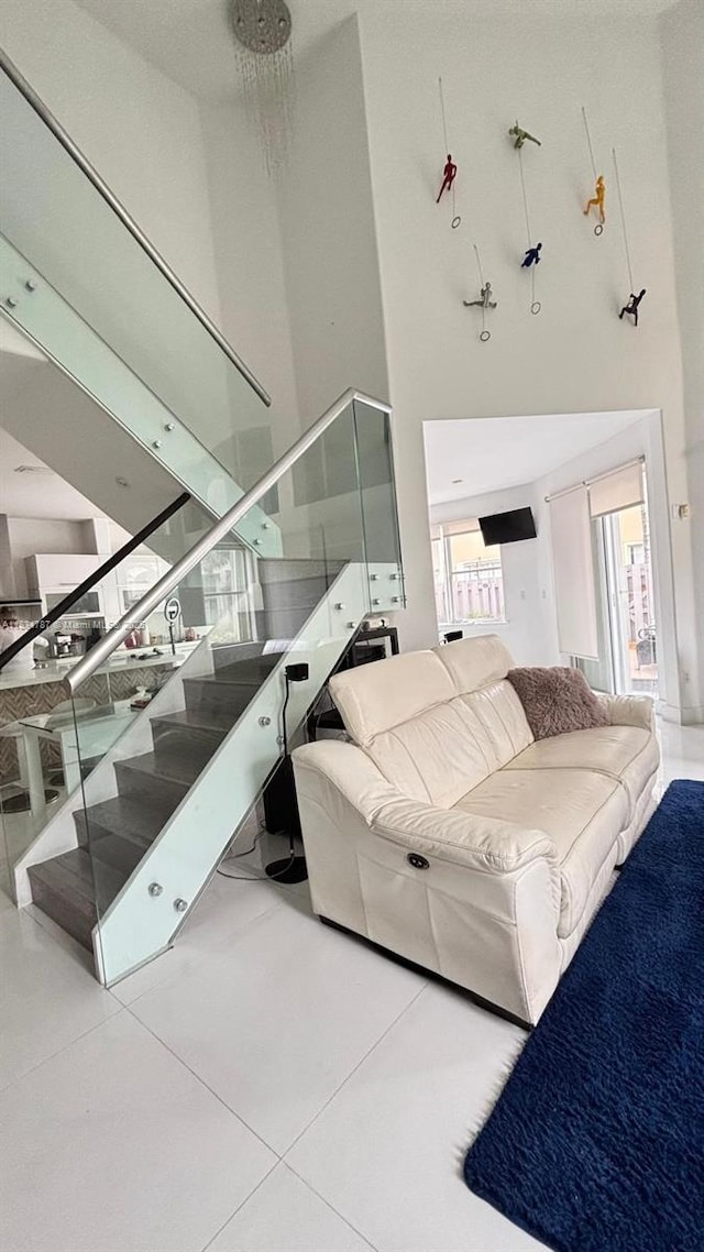 5490 NW 113th Ct, Doral, FL 33178 - living area with a towering ceiling and stairway