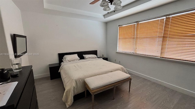 5490 NW 113th Ct, Doral, FL 33178 - bedroom featuring a tray ceiling, wood finished floors, and ceiling fan