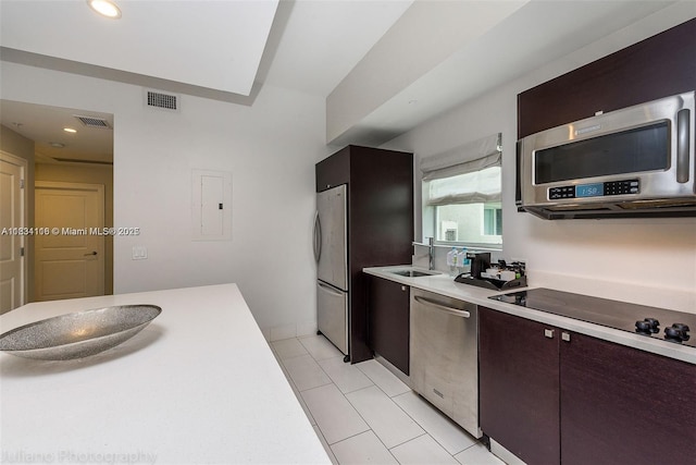 5300 NW 87th Ave Unit 1201, Doral, FL 33178 - kitchen featuring stainless steel appliances, light countertops, electric panel, light tile patterned floors, and dark brown cabinetry