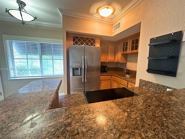 924 SE 2nd St Unit 9, Fort Lauderdale, FL 33301 - kitchen with stainless steel fridge, crown molding, a textured wall, glass insert cabinets, and black electric stovetop