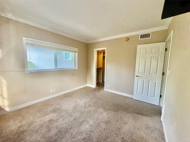 924 SE 2nd St Unit 9, Fort Lauderdale, FL 33301 - unfurnished bedroom featuring ornamental molding, carpet flooring, a walk in closet, a textured ceiling, and a closet