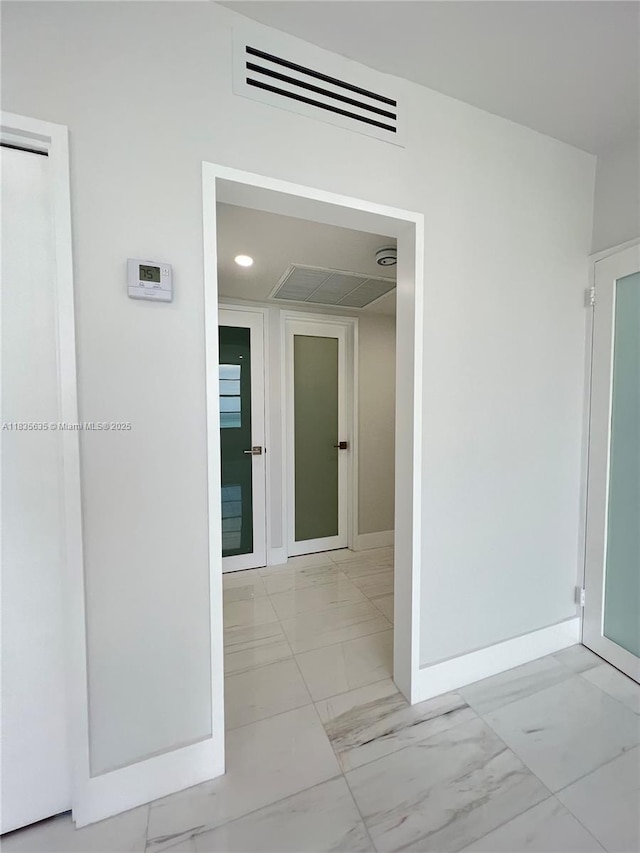 5700 Collins Ave Unit 16B, Miami Beach, FL 33140 - corridor featuring marble look tiles and baseboards