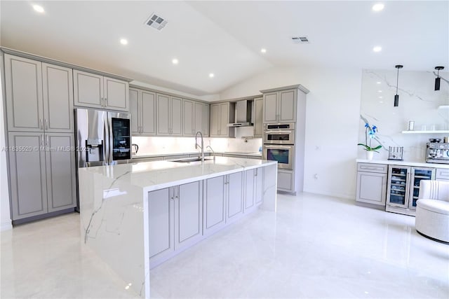 1149 SE Sandia Dr, Port St Lucie, FL 34983 - kitchen with gray cabinetry, appliances with stainless steel finishes, wine cooler, lofted ceiling, and a large island