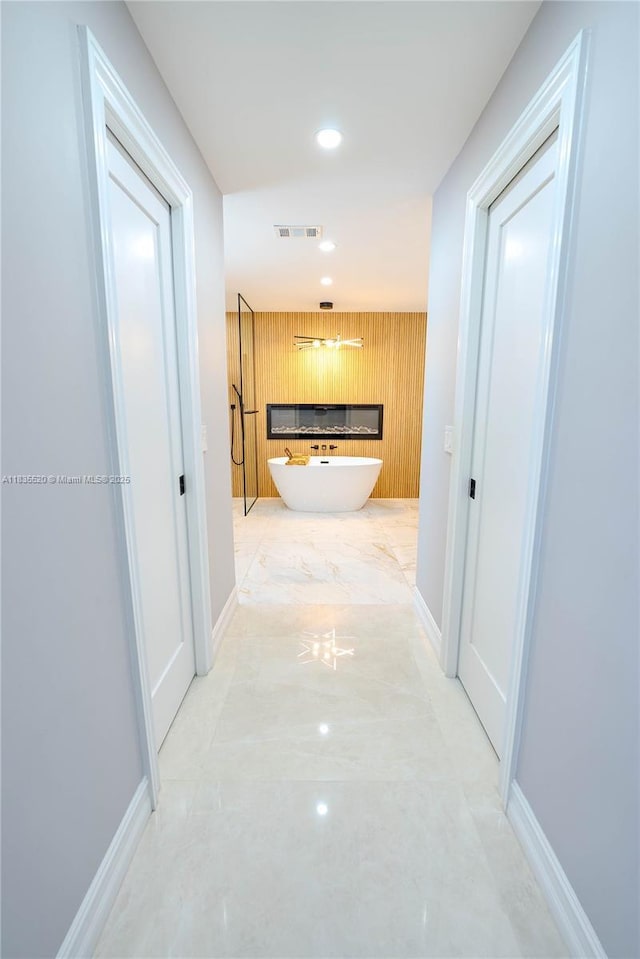 1149 SE Sandia Dr, Port St Lucie, FL 34983 - hallway with wood walls, recessed lighting, and an accent wall