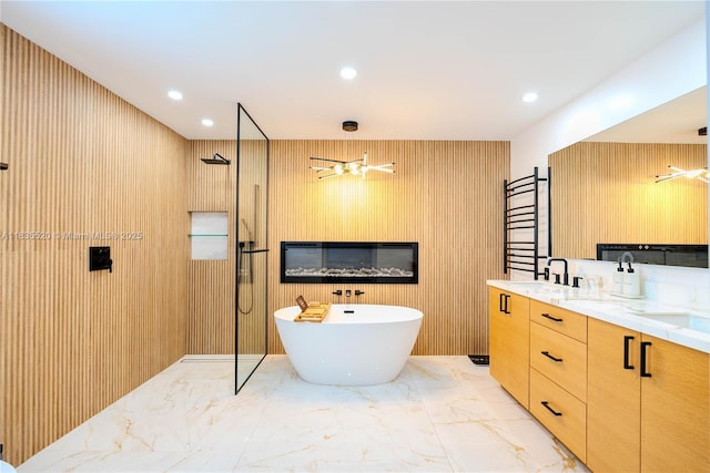 1149 SE Sandia Dr, Port St Lucie, FL 34983 - bathroom with a walk in shower, marble tiled flooring, a soaking tub, double vanity, and recessed lighting