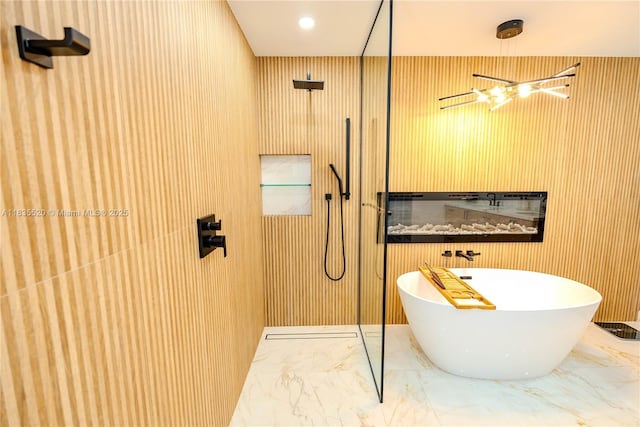 1149 SE Sandia Dr, Port St Lucie, FL 34983 - bathroom with a freestanding bath, walk in shower, and marble tiled floors