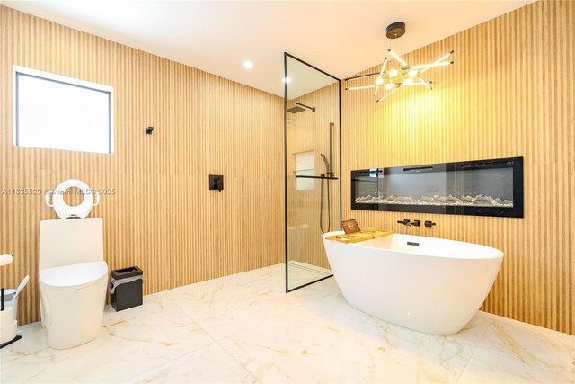 1149 SE Sandia Dr, Port St Lucie, FL 34983 - full bathroom featuring marble tiled floors, a freestanding tub, a walk in shower, and a chandelier