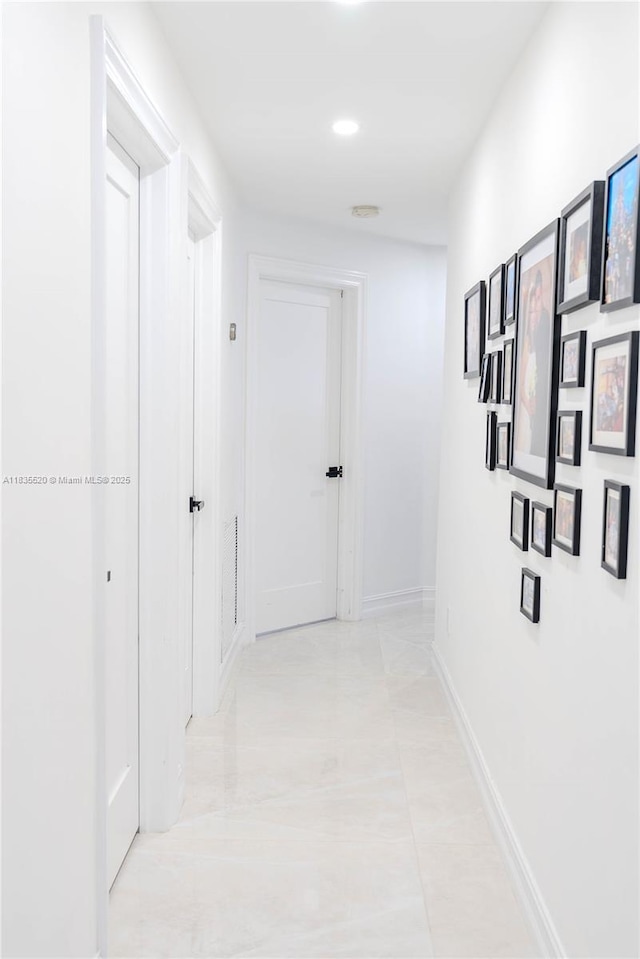 1149 SE Sandia Dr, Port St Lucie, FL 34983 - hallway featuring light tile patterned flooring and baseboards