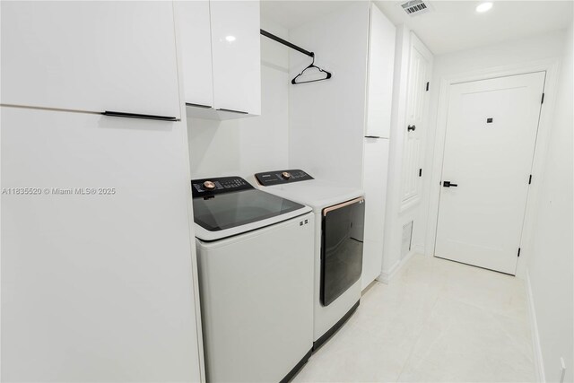 1149 SE Sandia Dr, Port St Lucie, FL 34983 - laundry area with washing machine and clothes dryer, cabinet space, and recessed lighting