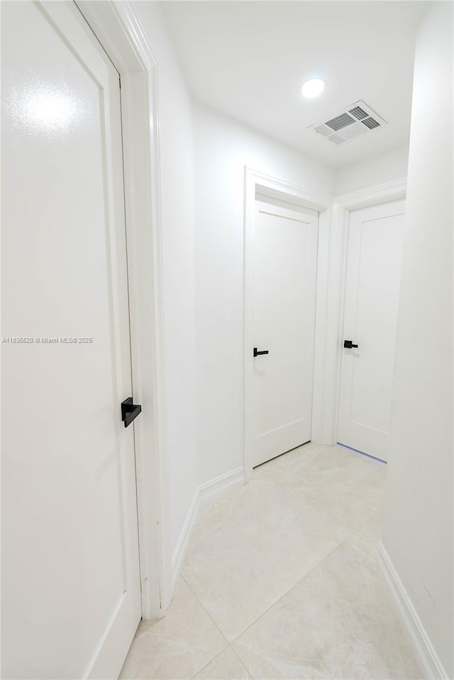 1149 SE Sandia Dr, Port St Lucie, FL 34983 - hallway with light tile patterned floors and baseboards