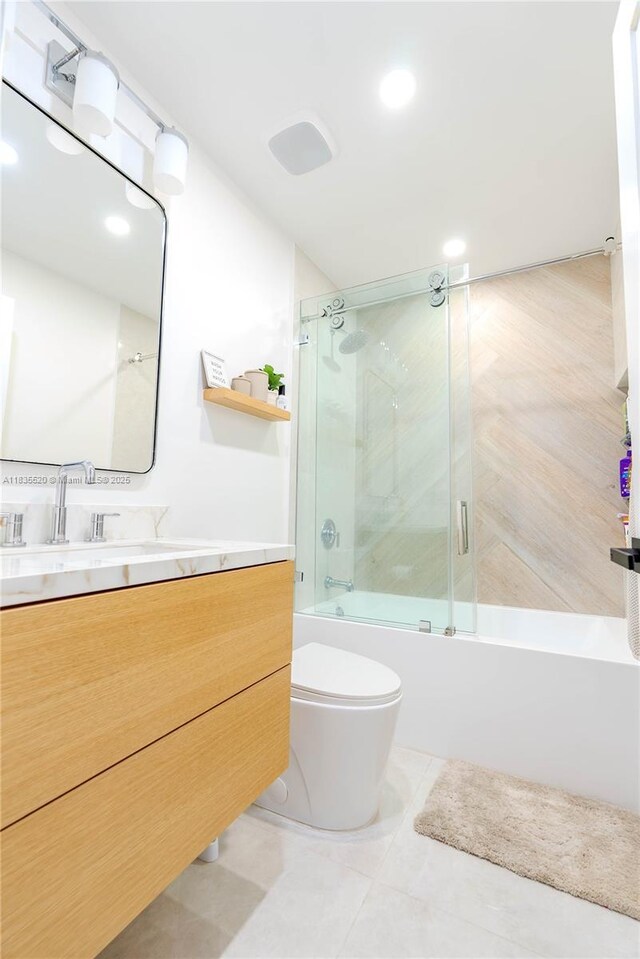 1149 SE Sandia Dr, Port St Lucie, FL 34983 - full bathroom featuring bath / shower combo with glass door, vanity, and tile patterned floors