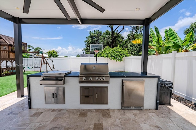 1149 SE Sandia Dr, Port St Lucie, FL 34983 - fenced backyard featuring area for grilling, a patio area, and a playground