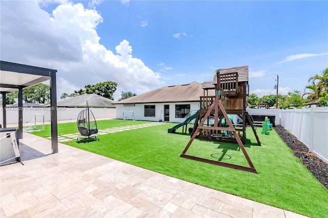 1149 SE Sandia Dr, Port St Lucie, FL 34983 - view of jungle gym featuring a fenced backyard and a patio